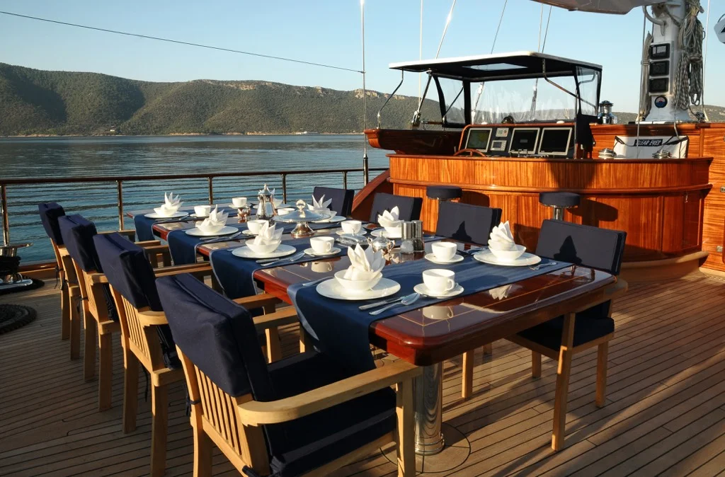 Sophisticated outdoor dining setup on S/Y Clear Eyes teak deck with panoramic Mediterranean sea views