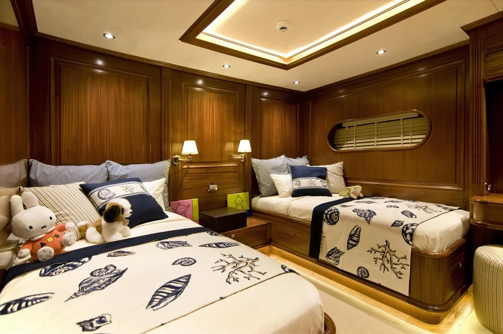 Twin cabin interior showcasing natural light through porthole on S/Y Clear Eyes Mediterranean charter yacht
